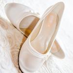 bridal shoes on bed